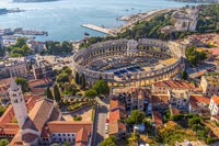 Pula is a coastal town in Croatia known for its stunning Roman amphitheater.